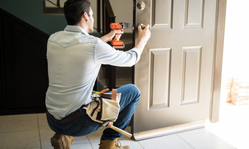 Contractor installing door lock